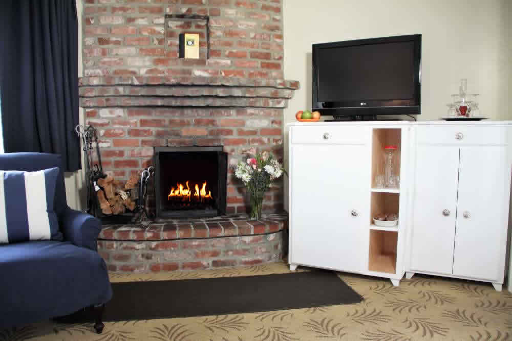 chair, fireplace and TV